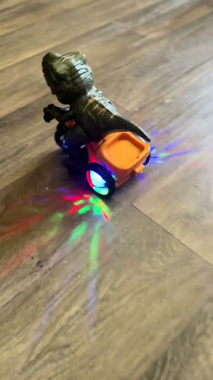 Actual dinosaur tricycle rolling on a flat floor with illuminated rear wheels