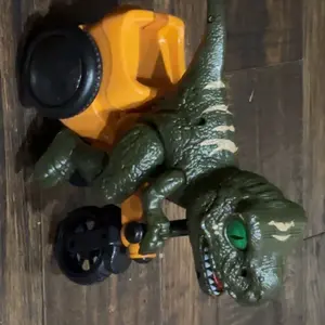 Customer side view of the green dinosaur and yellow tricycle