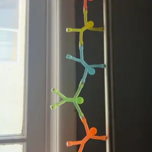 Customer photo of magnetic figures connected in a chain beside a window.