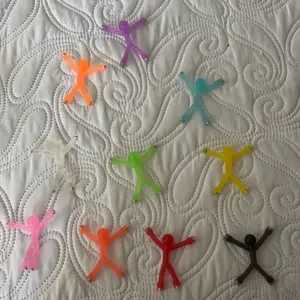 Customer photo of ten translucent magnetic figures laid out on a quilt.